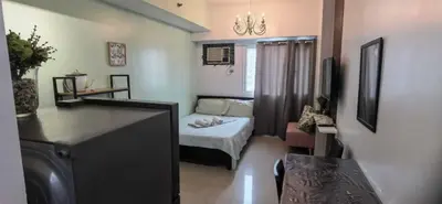 a small room with a bed and a desk at OYO 1172 MVM Transient House in Manila