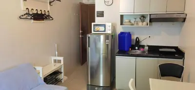 a small kitchen with a sink and a refrigerator at OYO 1172 MVM Transient House in Manila
