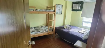 a bedroom with two bunk beds and a window at OYO 1172 MVM Transient House in Manila