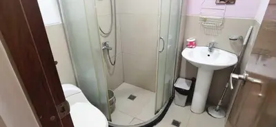a bathroom with a shower and a toilet and a sink at OYO 1172 MVM Transient House in Manila
