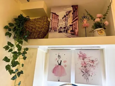 a shelf with a picture of a woman in a pink dress at Twins Nest - CASA VICENTE Cozy 2-Bedroom Loft Condo Mandaluyong in Manila
