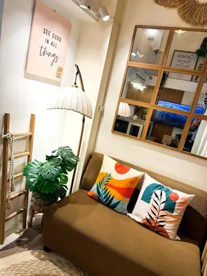 a living room with a couch and a lamp at Twins Nest - CASA VICENTE Cozy 2-Bedroom Loft Condo Mandaluyong in Manila