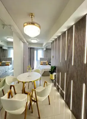 a room with a table and chairs and a bedroom at Sweet Escape at S Residences in Manila