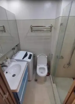 a bathroom with a sink and a toilet and a shower at Sweet Escape at S Residences in Manila