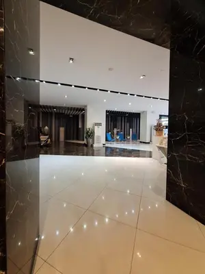 a lobby with a white floor and black walls at Eastwood Legrand3 Studio Type condo in Manila