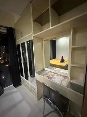 a room with a bedroom with a mirror and a chair at Wheng Place at Shell Residences MOA in Manila