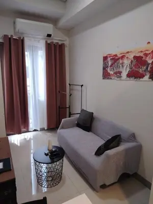 a living room with a couch and a table at Good Luck House at S RESIDENCES in Manila