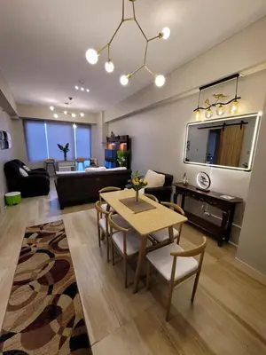 a living room with a table and a couch at Amazing 1 5BR unit Connected to Eastwood Mall in Manila