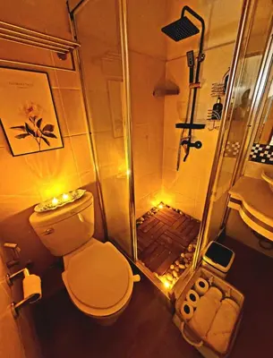 a bathroom with a shower with a toilet and a sink at Stunning Suite 10 Steps from Eastwood Mall in Manila