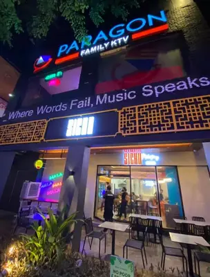 a restaurant with tables and chairs outside at night at Stunning Suite 10 Steps from Eastwood Mall in Manila