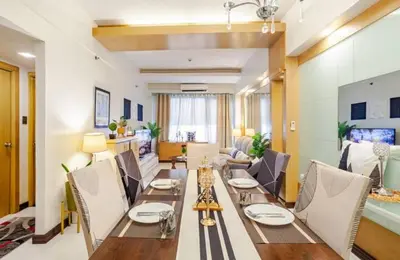 a dining room with a long table and chairs at Stunning Suite 10 Steps from Eastwood Mall in Manila