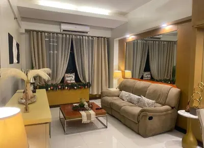 a living room with a couch and a table at Stunning Suite 10 Steps from Eastwood Mall in Manila