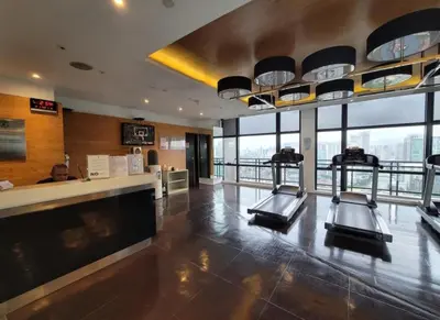 a gym with cardio equipment in a building at Incredible Makati Studio Unit w Stunning view & 65 TV in Manila