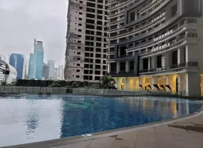 a large swimming pool in a city with tall buildings at Incredible Makati Studio Unit w Stunning view & 65 TV in Manila