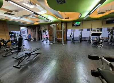 a gym with a lot of treadmills and machines at Incredible Makati Studio Unit w Stunning view & 65 TV in Manila
