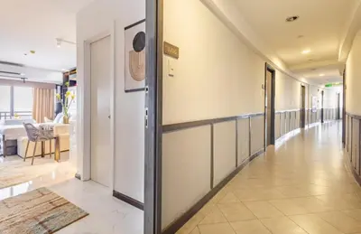 an empty hallway with a hallway leading to a living room at Incredible Makati Studio Unit w Stunning view & 65 TV in Manila