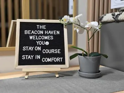 a sign that says the beacon haven welcomes you to stay on course stay in concert at The Beacon Haven in Trece Martires