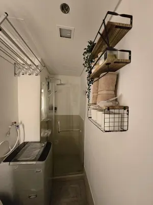 a bathroom with a shower and a toilet and a sink at The Beacon Haven in Trece Martires