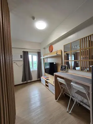 a living room with a desk and a television at The Beacon Haven in Trece Martires
