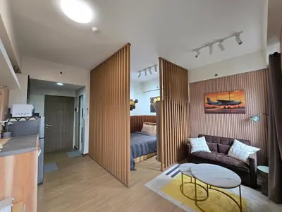 a living room with a couch and a bed at The Beacon Haven in Trece Martires