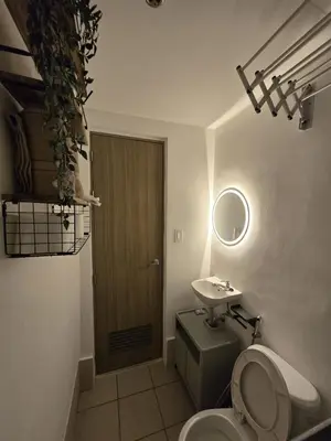 a bathroom with a toilet and a sink at The Beacon Haven in Trece Martires