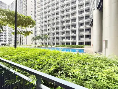 a view of a building with a swimming pool at ClaySky Staycation at Shore 2 Residences Tower 2 near Mall of Asia- Hotel Set Up in Amenity and Pool Level with Netflix, HBO Max & Youtube Premium in Manila