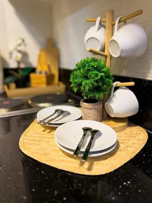 two white plates and a potted plant on a counter at Newly-furnished 1BR with Balcony near MRT Mandaluyong in Manila