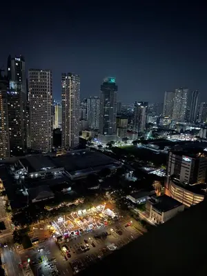 a view of a city at night with buildings at Newly-furnished 1BR with Balcony near MRT Mandaluyong in Manila