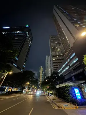 a city street at night with tall buildings at Newly-furnished 1BR with Balcony near MRT Mandaluyong in Manila