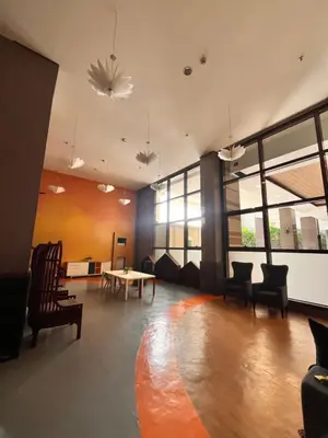 a large room with chairs and a table and windows at Radiance Manila Bay Bayview Comfort with Pool & Pet-Friendly in Manila