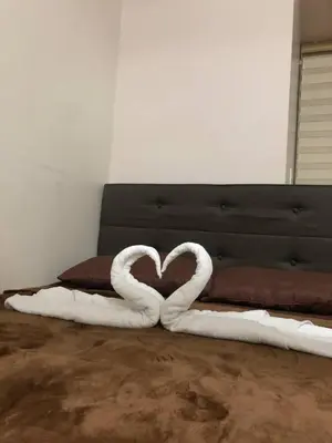 a heart made out of white towels on a bed at Estancias De Sofielo in Manila