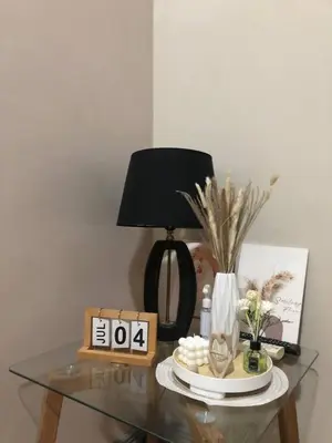 a glass table with a lamp on top of it at Estancias De Sofielo in Manila