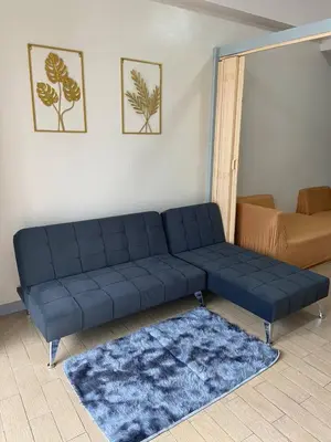 a blue couch sitting in a living room at Estancias De Sofielo in Manila