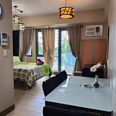 a room with a bed and a table and a room at LDN Secret Crib 3P - Two Palm in Manila