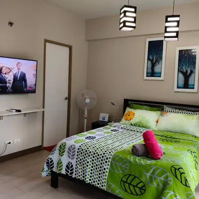a bedroom with a bed and a tv on the wall at LDN Secret Crib 3P - Two Palm in Manila