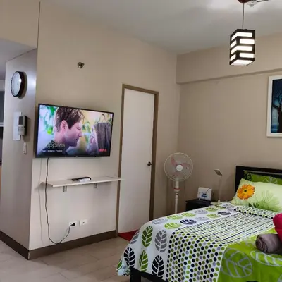 a bedroom with a bed and a tv on the wall at LDN Secret Crib 3P - Two Palm in Manila