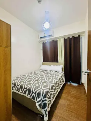 a bedroom with a bed in a room at Palm Beach West - Baler Tower in Manila