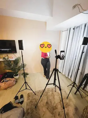 a person standing in a room with a camera at Kozy Mood Studio in Manila