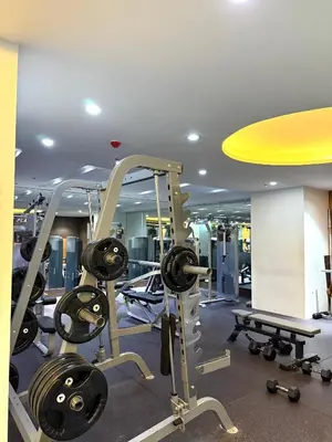 a gym with treadmills and machines in a room at Flat 316 Modern Minimalist Studio Near Makati BGC in Manila