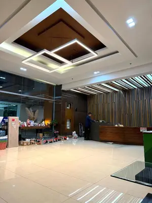 a lobby with a man standing in the middle at Flat 316 Modern Minimalist Studio Near Makati BGC in Manila
