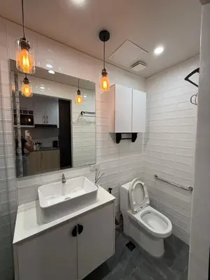 a white bathroom with a sink and a toilet at Flat 316 Modern Minimalist Studio Near Makati BGC in Manila