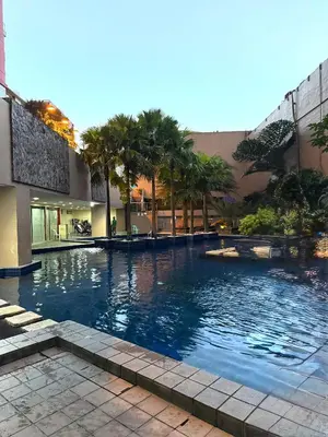 a swimming pool in the middle of a building at Flat 316 Modern Minimalist Studio Near Makati BGC in Manila