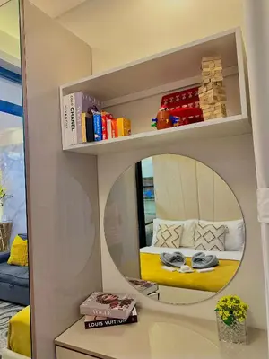 a room with a mirror and a bed in a room at Golden Sunset Suite in Manila