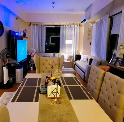 a living room with a couch and a table at Spectacular Penthouse with Stunning Balcony in Eastwood Mall in Manila