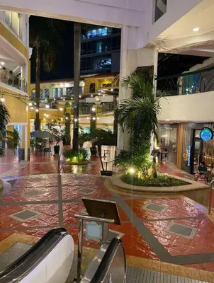 a lobby with a laptop on a table in a building at Spectacular Penthouse with Stunning Balcony in Eastwood Mall in Manila