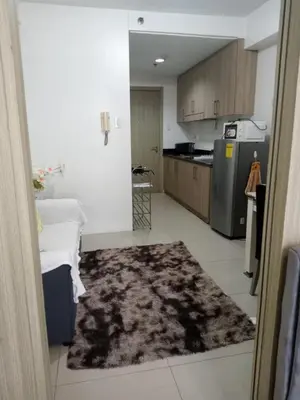 a kitchen with a rug in the middle of a room at Like home staycation in Manila