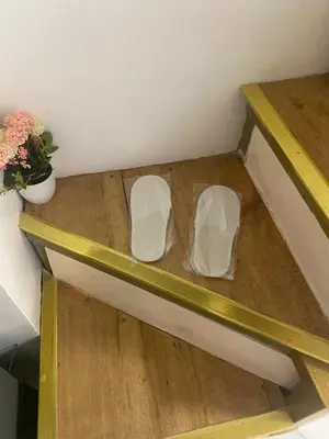 two shelves in a room with a vase of flowers at Elegant Golden Loft with Mood Lighting Central Location and Skyline Views in Manila