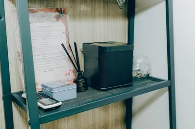 a shelf with a computer on top of it at Budget staycation near moa in Manila