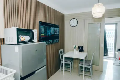 a kitchen with a small table and a microwave at Budget staycation near moa in Manila