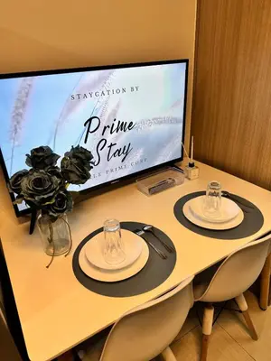 a table with two plates and a sign on it at Room 643 Pool View Shore 2 Residences near PICC & SM MOA by Prime Stay in Manila